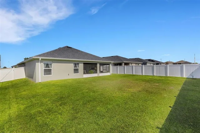 a view of a field with a tree in the background