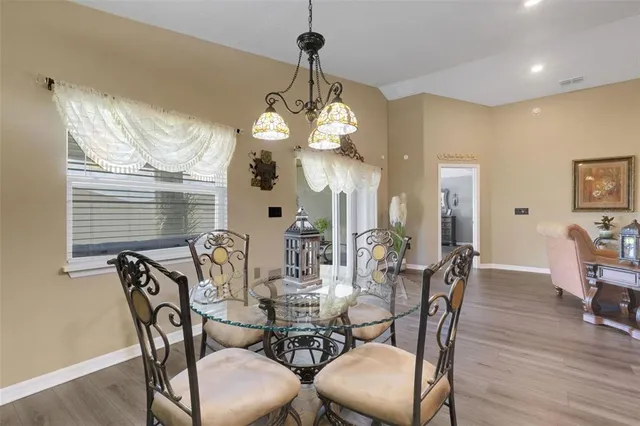 a view of a dining room with furniture wooden floor and chandelier