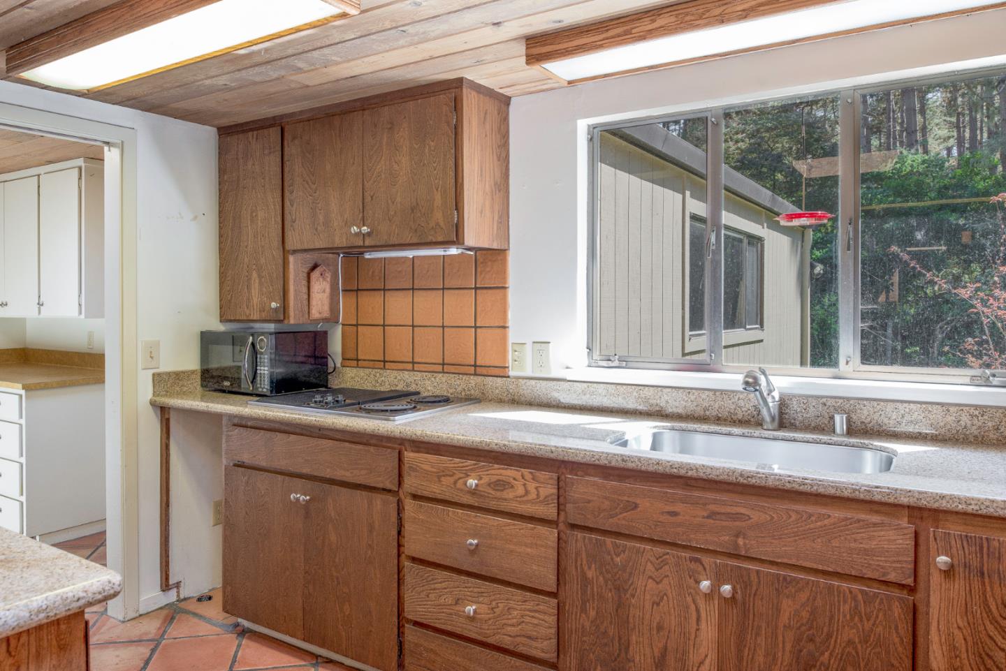 1280 Viscaino Road Pebble Beach, CA 93953 - Photo 11 of 48 a kitchen with a sink and cabinets