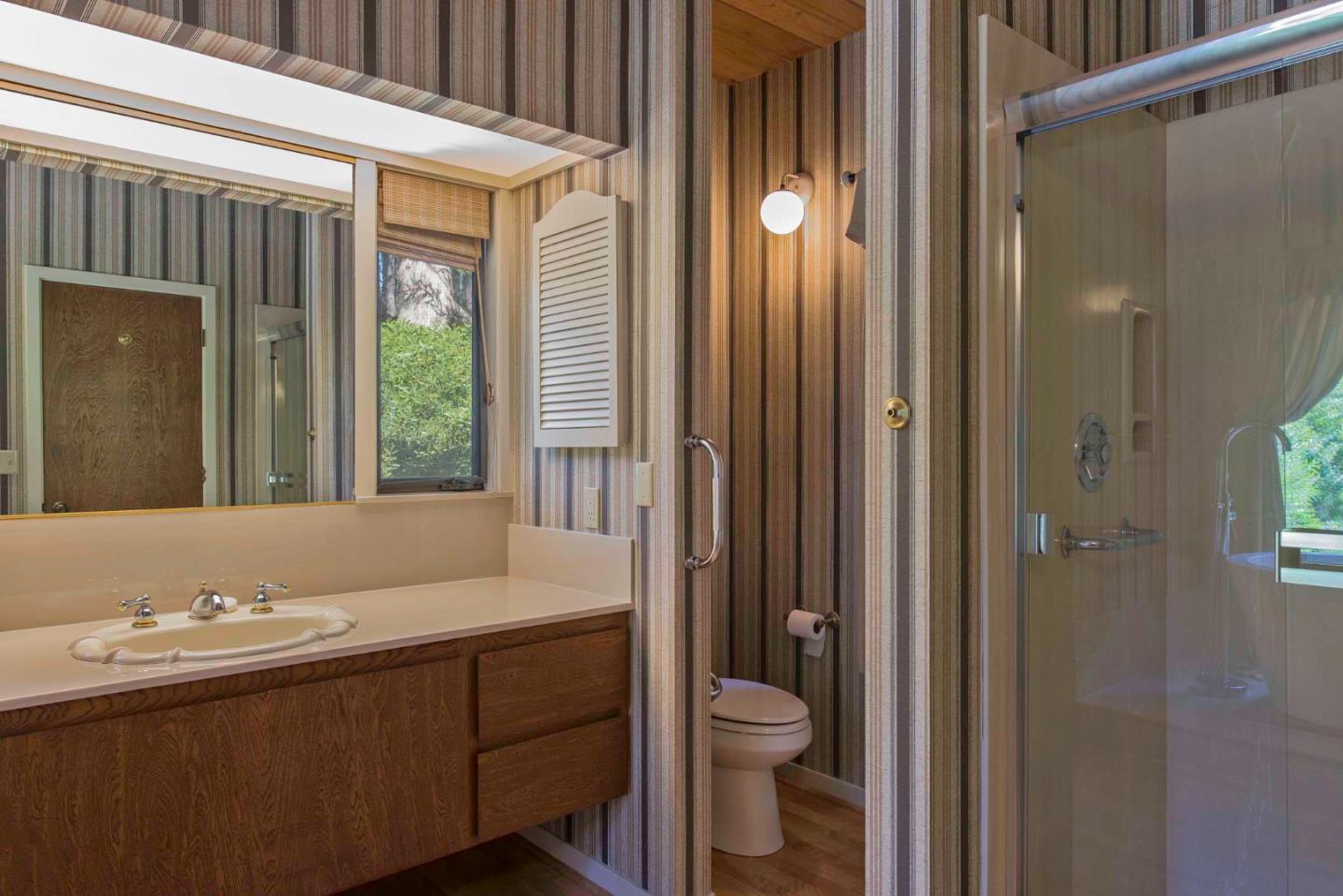 1280 Viscaino Road Pebble Beach, CA 93953 - Photo 18 of 48 a bathroom with a sink and a mirror