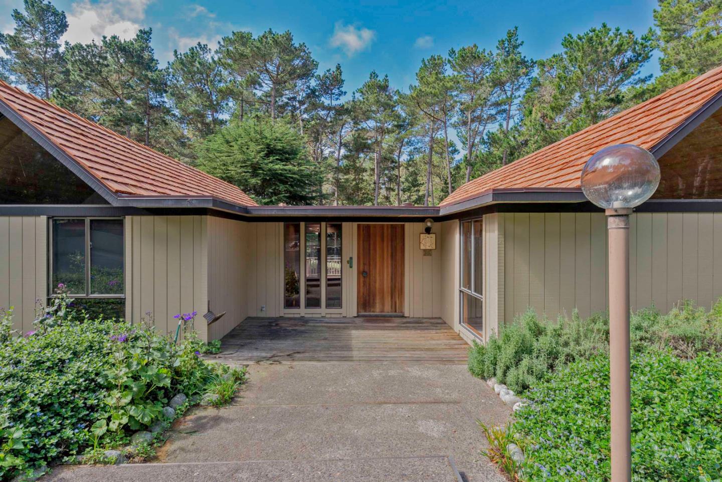 1280 Viscaino Road Pebble Beach, CA 93953 - Photo 27 of 48 a front view of a house with garden