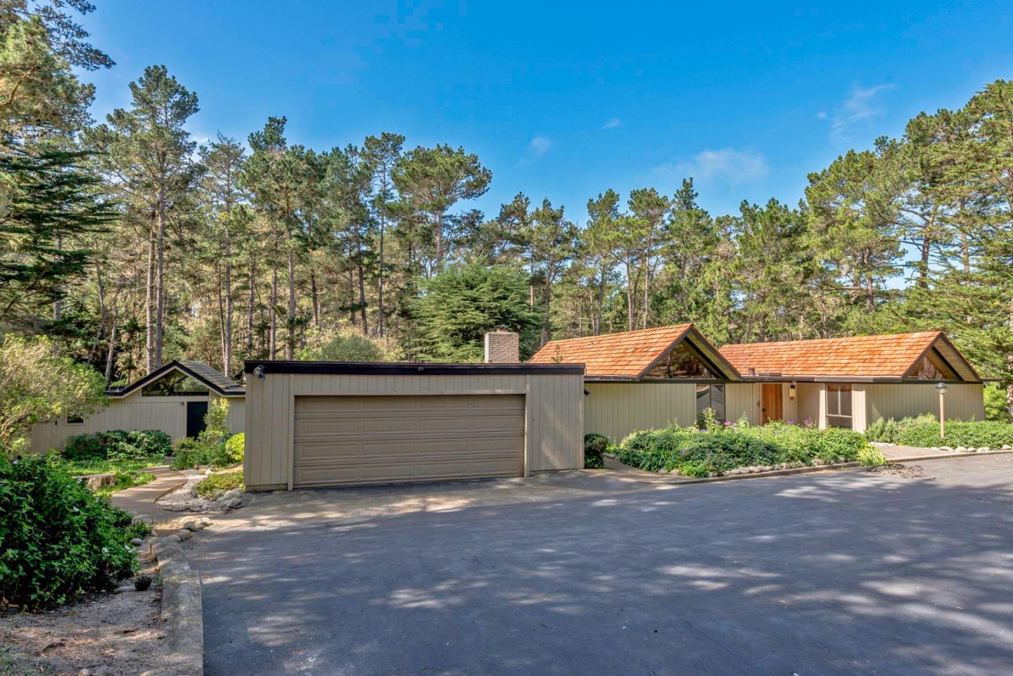 1280 Viscaino Road Pebble Beach, CA 93953 - Photo 30 of 48 a front view of a house with a yard and garage