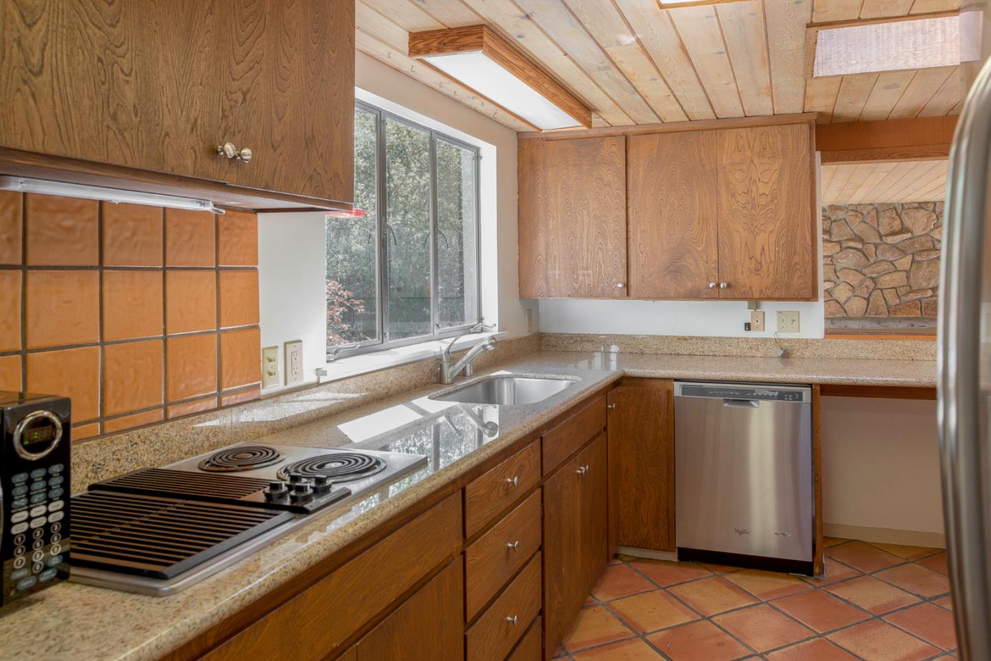 1280 Viscaino Road Pebble Beach, CA 93953 - Photo 38 of 48 a kitchen with a sink stove and cabinets