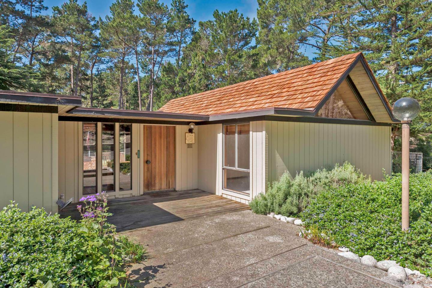 1280 Viscaino Road Pebble Beach, CA 93953 - Photo 4 of 48 a front view of a house with garden