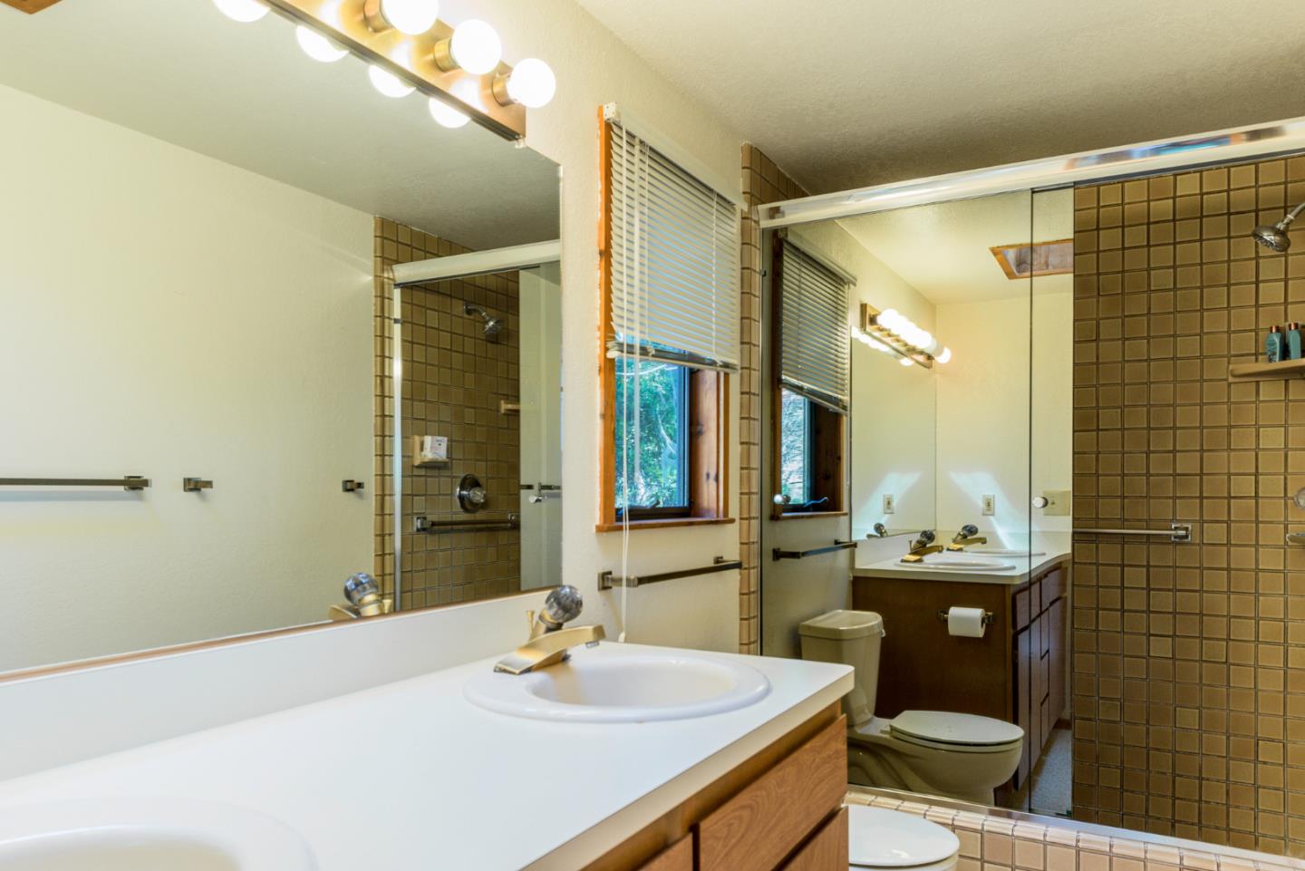 1280 Viscaino Road Pebble Beach, CA 93953 - Photo 48 of 48 a bathroom with a sink and a mirror