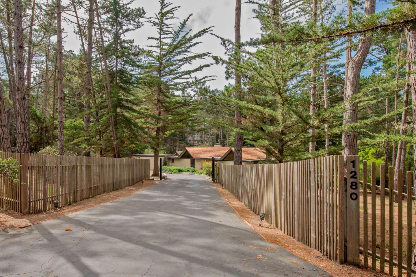 1280 Viscaino Road Pebble Beach, CA 93953 - Photo 6 of 48 a view of a wooden fence and trees