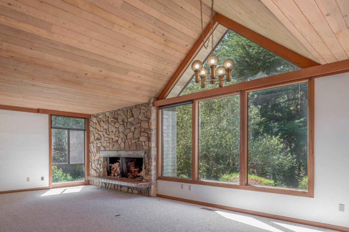 1280 Viscaino Road Pebble Beach, CA 93953 - Photo 8 of 48 a view of an empty room with a fireplace
