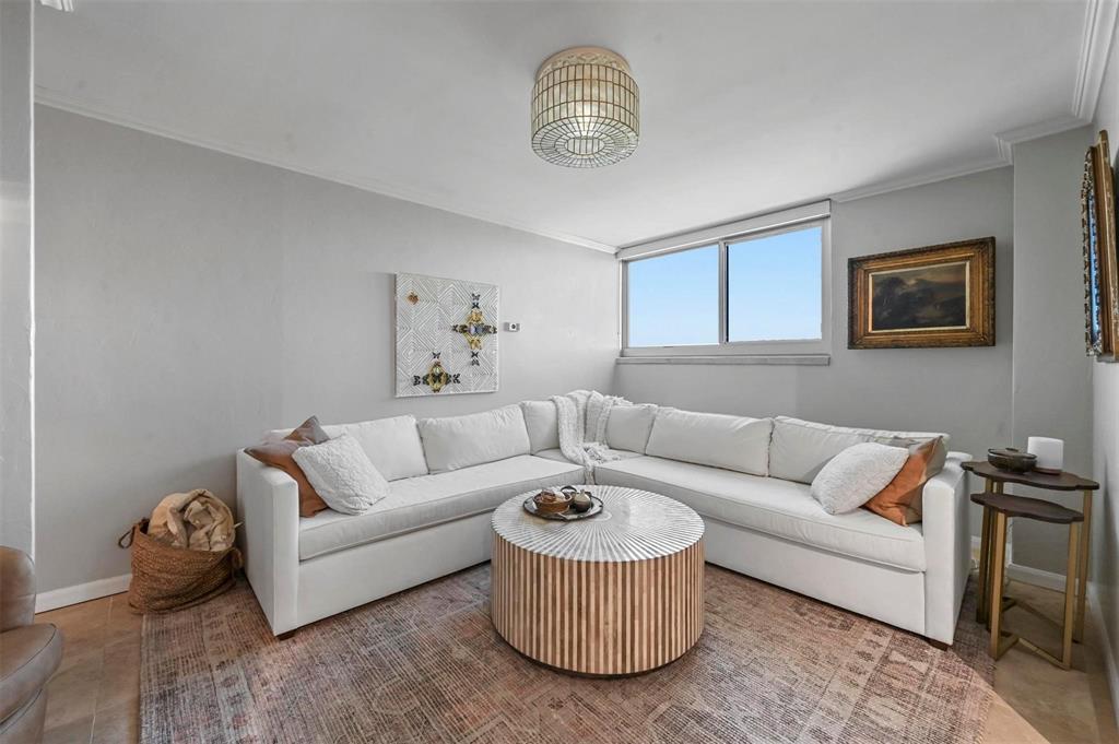 3883 Turtle Creek Boulevard, Unit 2015 Dallas, TX 75219 - Photo 12 of 31 marble living room featuring ornamental molding