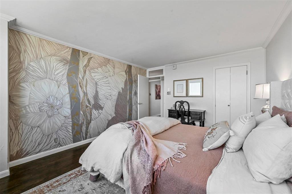 3883 Turtle Creek Boulevard, Unit 2015 Dallas, TX 75219 - Photo 19 of 31 Bedroom featuring ornamental molding, wood finished floors, and a closet