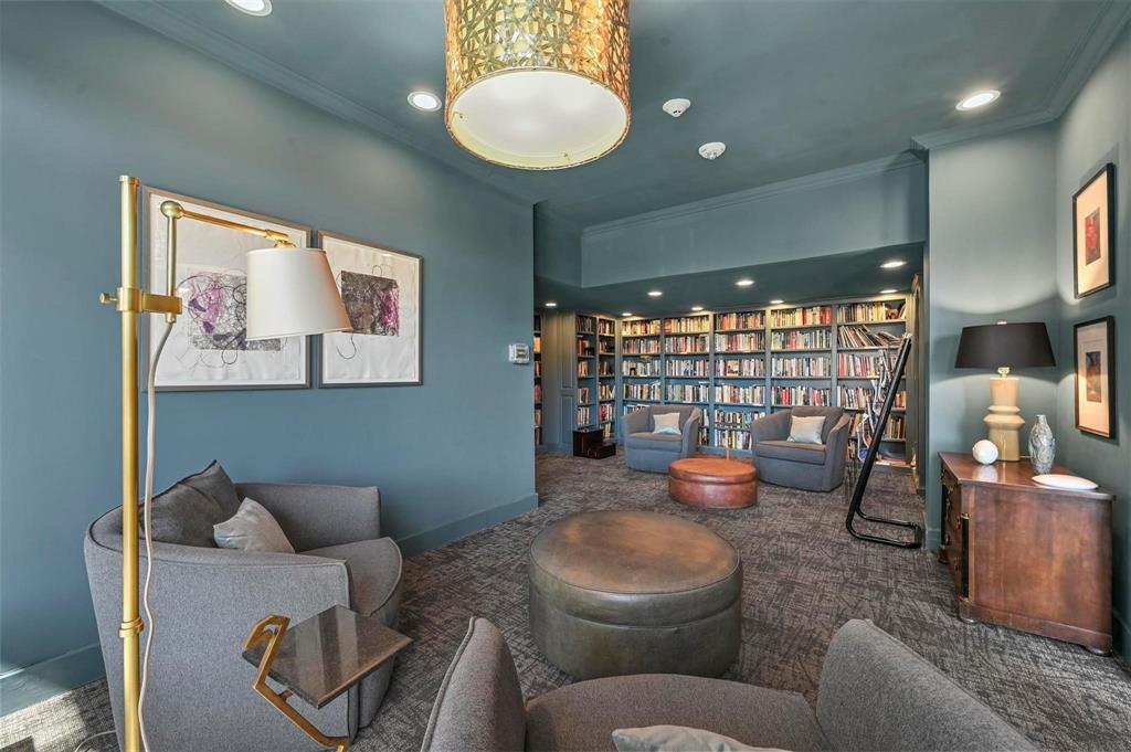 3883 Turtle Creek Boulevard, Unit 2015 Dallas, TX 75219 - Photo 23 of 31 Living area featuring recessed lighting, carpet, bookshelves, and ornamental molding