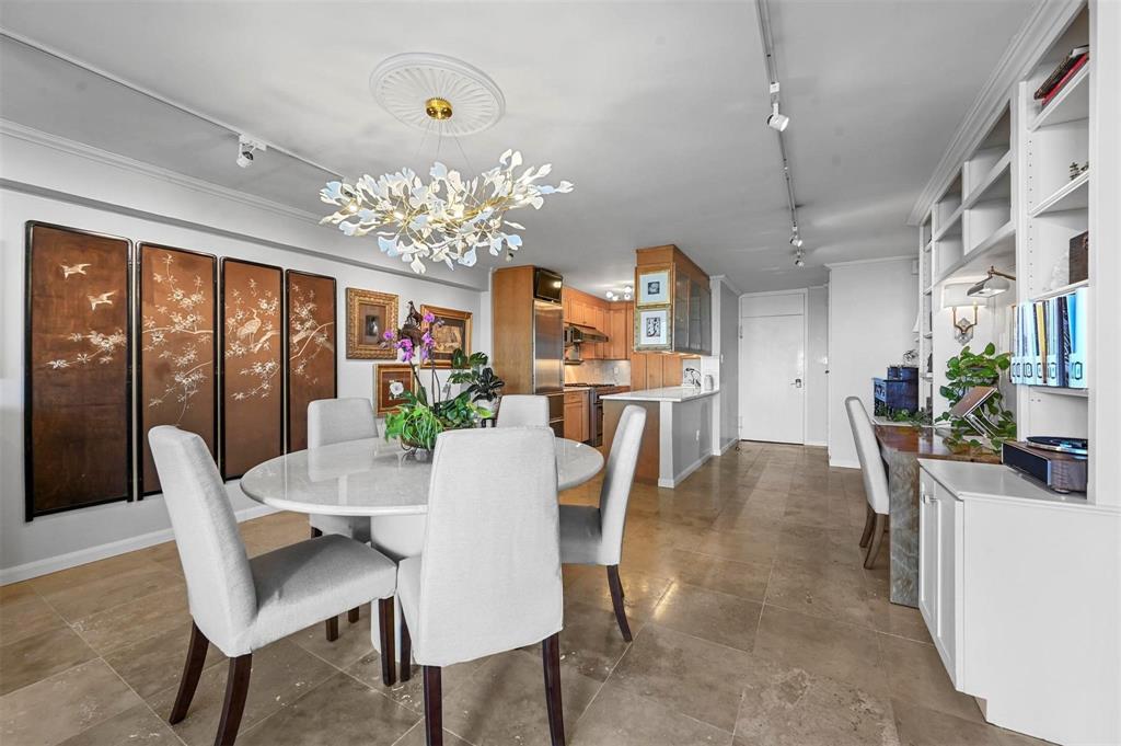 3883 Turtle Creek Boulevard, Unit 2015 Dallas, TX 75219 - Photo 10 of 31 Dining space featuring rail lighting and a chandelier