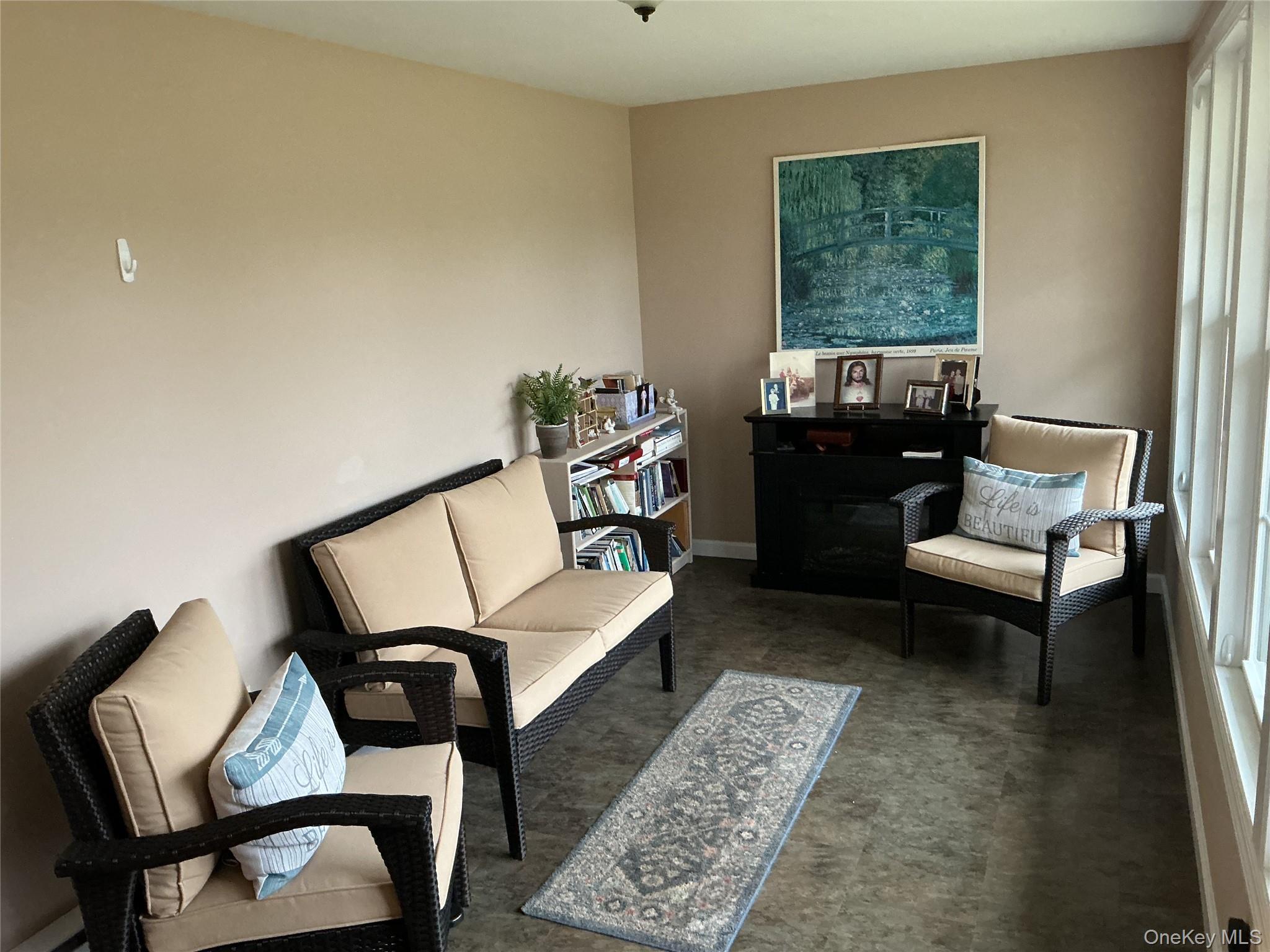 207 Woodbridge Drive, Unit B Ridge, NY 11961 - Photo 13 of 22 a living room with furniture and a window