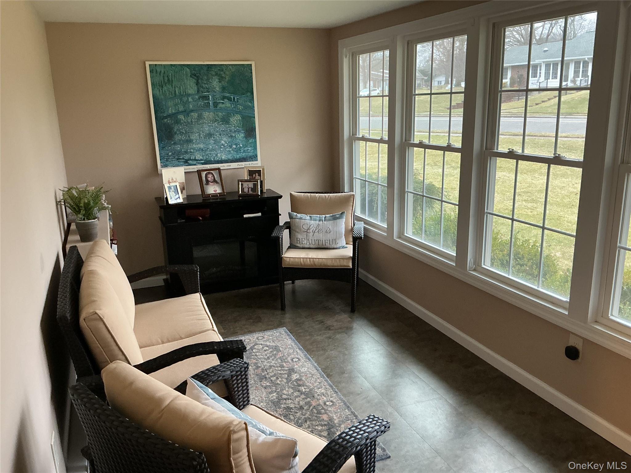 207 Woodbridge Drive, Unit B Ridge, NY 11961 - Photo 14 of 22 a living room with furniture and a window