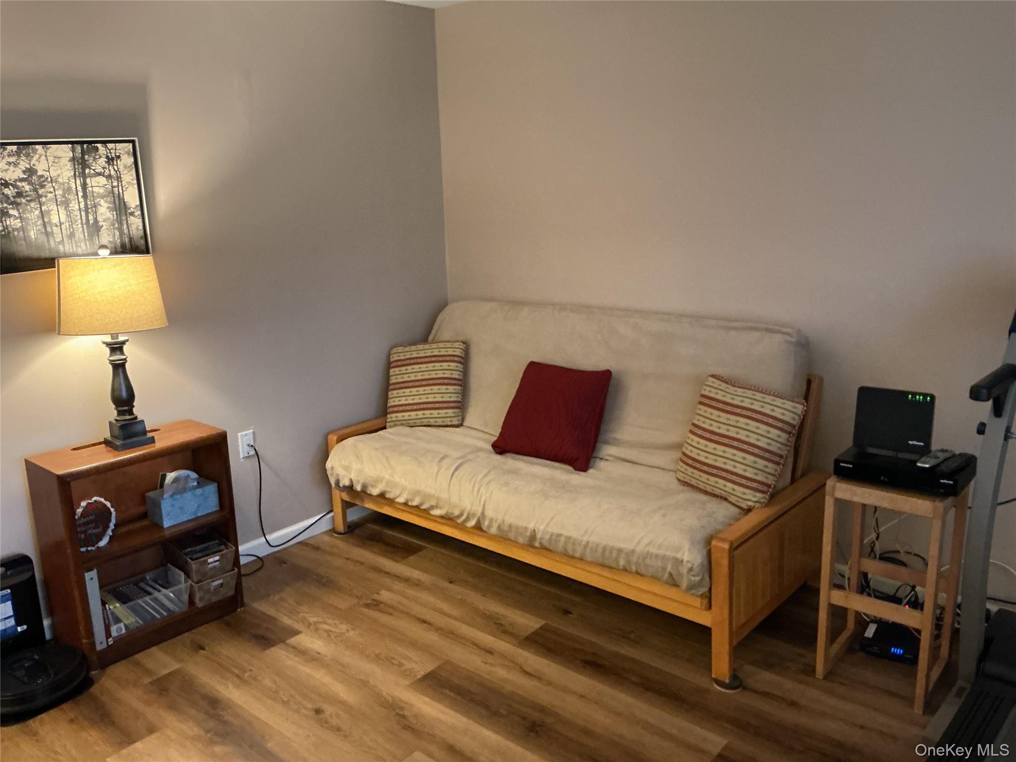 207 Woodbridge Drive, Unit B Ridge, NY 11961 - Photo 15 of 22 a bedroom with a bed and a flat tv screen on a dresser