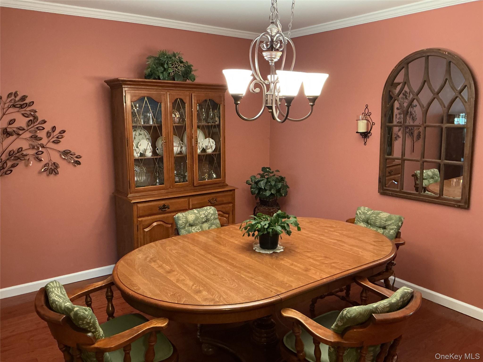 207 Woodbridge Drive, Unit B Ridge, NY 11961 - Photo 19 of 22 a view of a dining room with furniture and wooden floor