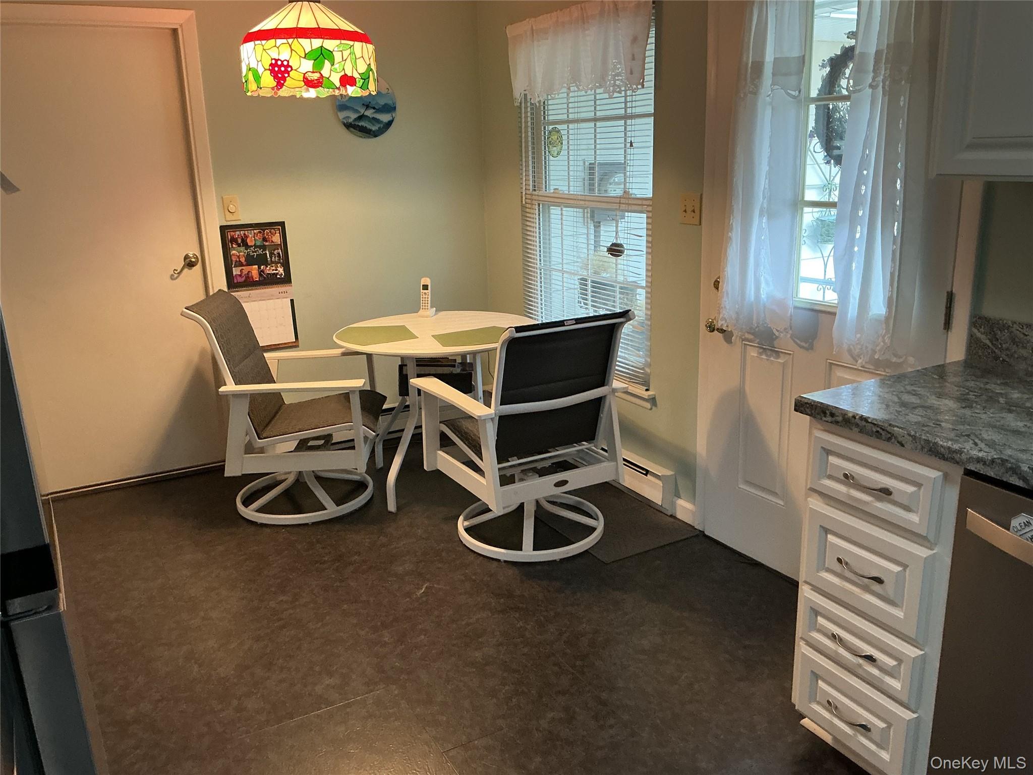 207 Woodbridge Drive, Unit B Ridge, NY 11961 - Photo 7 of 22 a room with furniture and a window