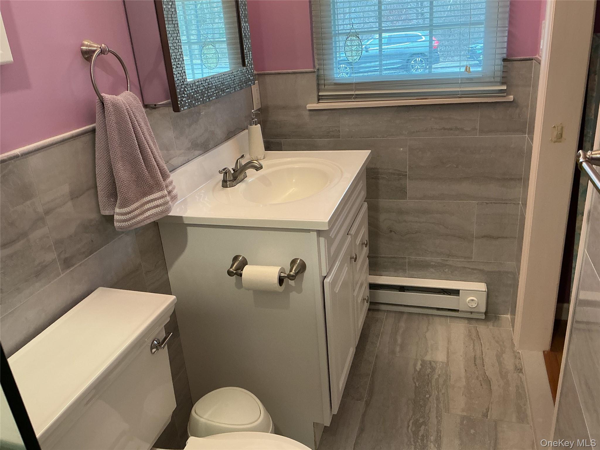 207 Woodbridge Drive, Unit B Ridge, NY 11961 - Photo 8 of 22 a bathroom with a sink toilet and shower