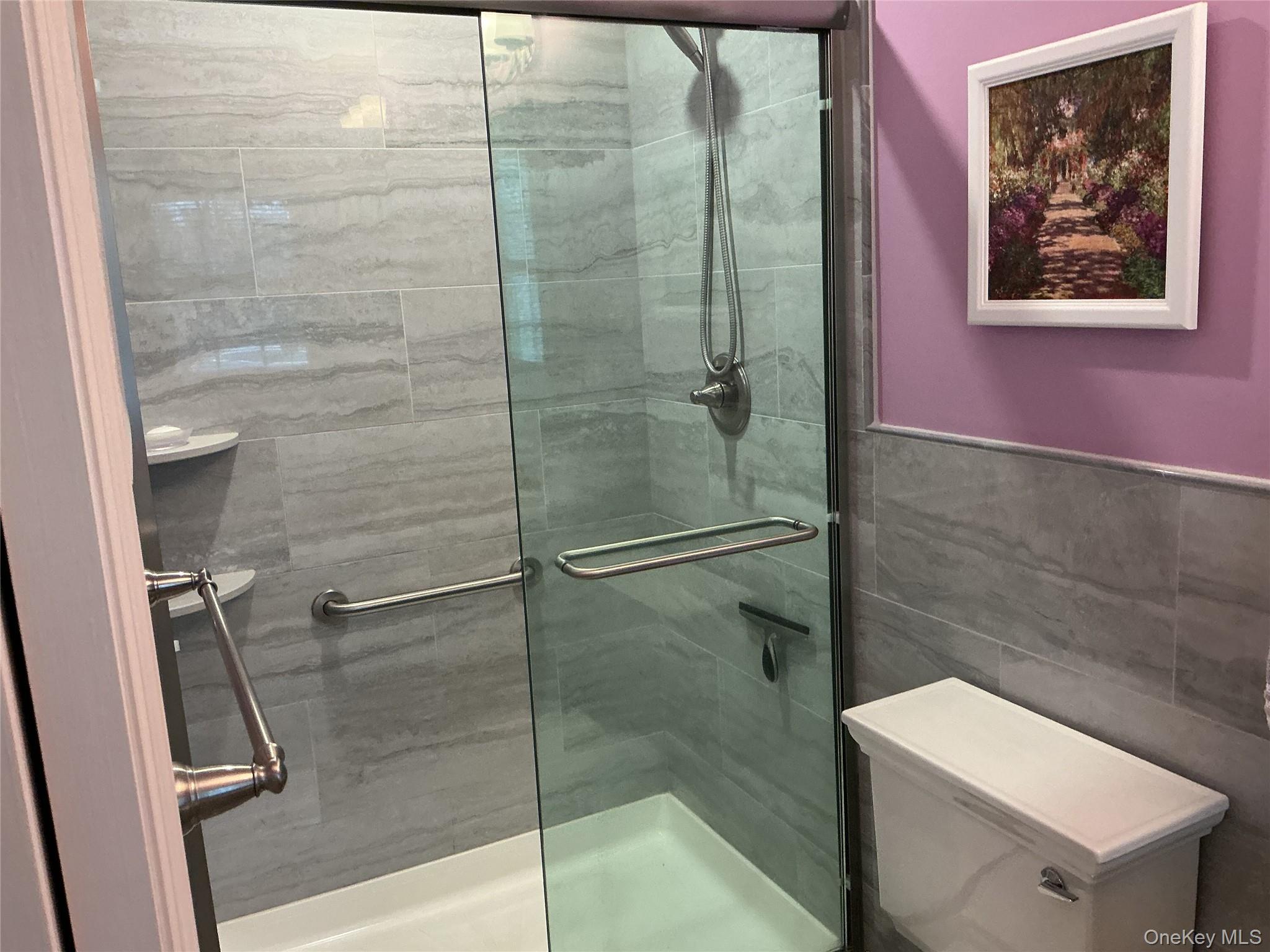 207 Woodbridge Drive, Unit B Ridge, NY 11961 - Photo 9 of 22 a bathroom with a shower and toilet