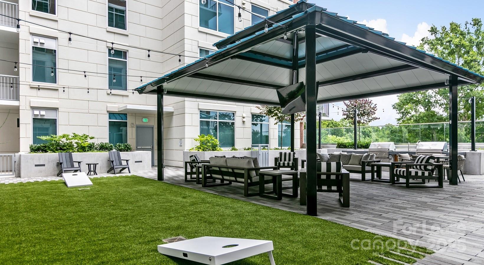 4425 Sharon Road, Unit 2F Charlotte, NC 28211 - Photo 7 of 44 a view of a patio with table and chairs potted plants with a garden