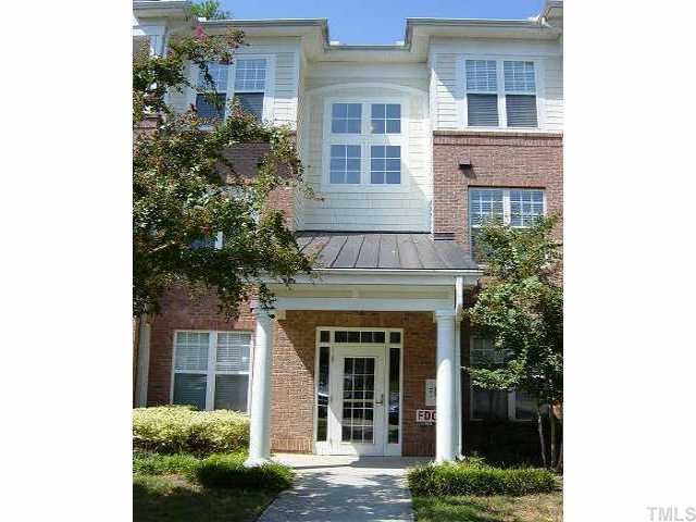 1710 Tiffany Bay Court Raleigh, NC 27609 - Photo 1 of 1 a view of a brick house with large windows and a large window