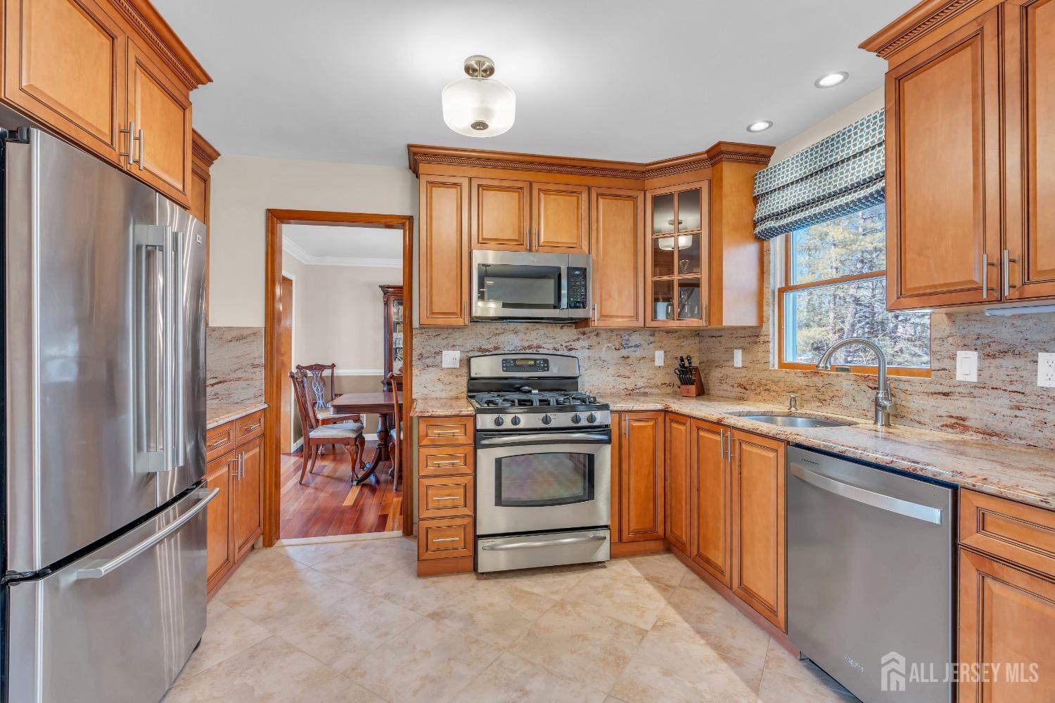 14 Daniel Place Old Bridge, NJ 07747 - Photo 11 of 38 a kitchen with stainless steel appliances granite countertop a stove top oven a sink and a refrigerator