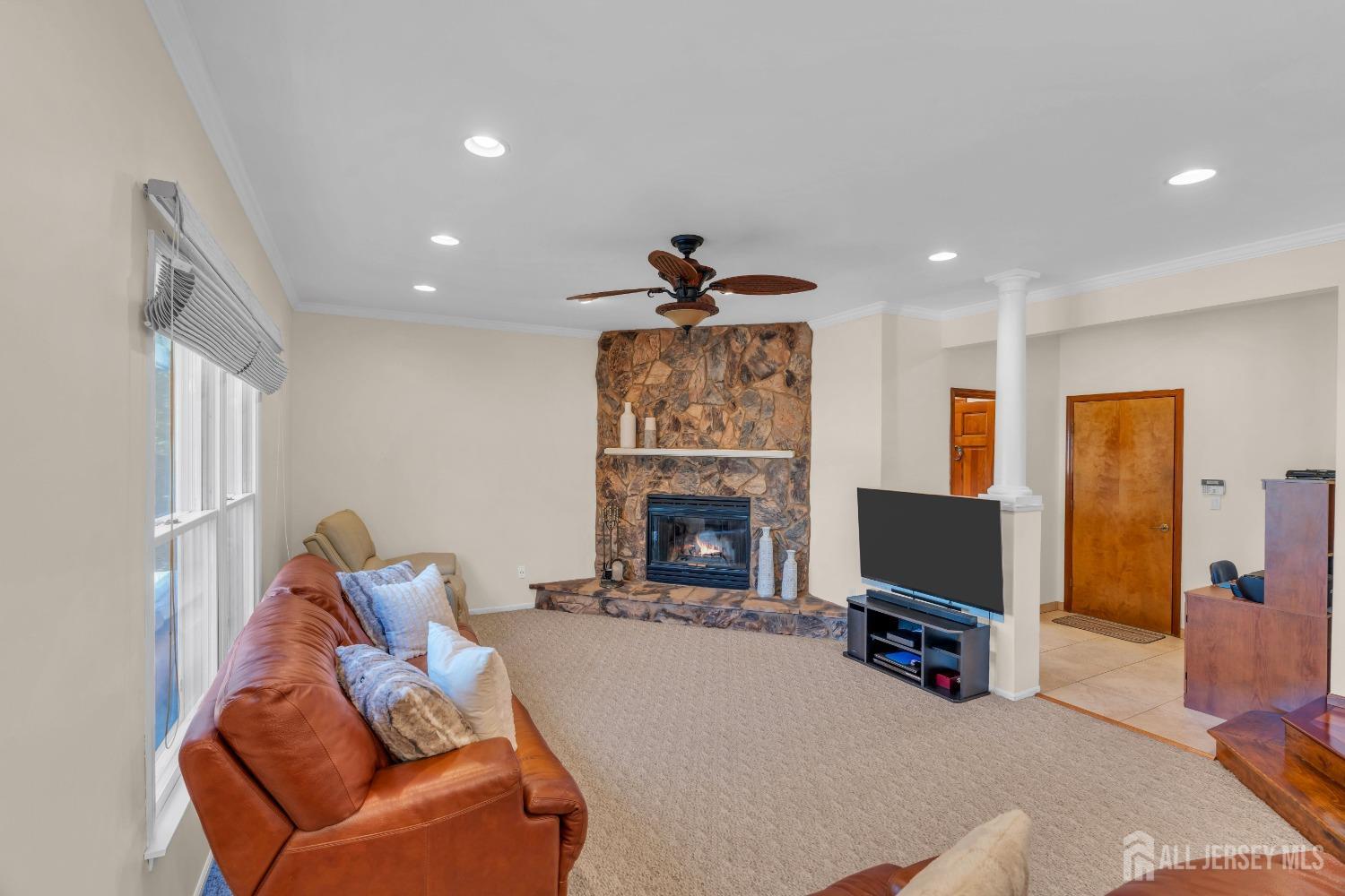 14 Daniel Place Old Bridge, NJ 07747 - Photo 12 of 38 a living room with furniture a fireplace and a flat screen tv