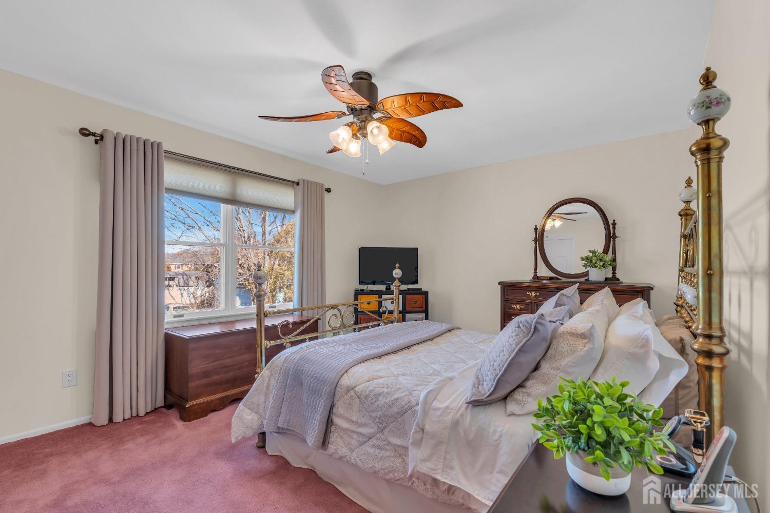 14 Daniel Place Old Bridge, NJ 07747 - Photo 23 of 38 a bedroom with a bed and a chandelier