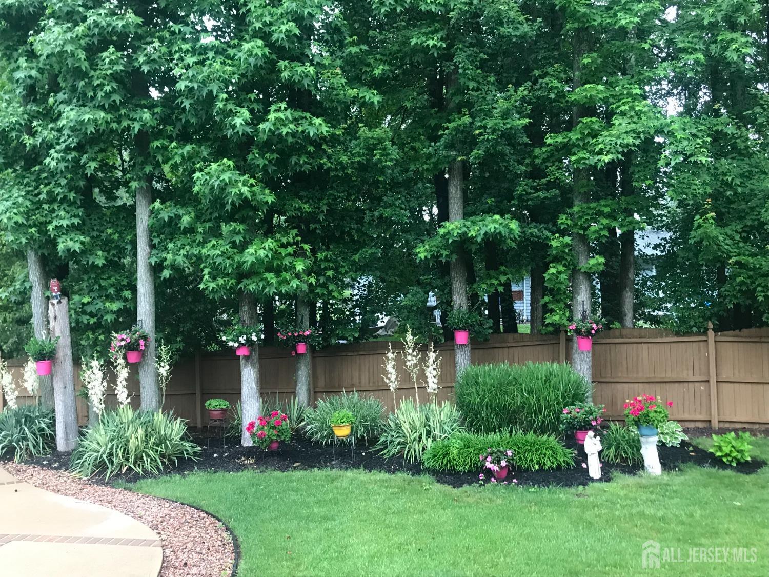 14 Daniel Place Old Bridge, NJ 07747 - Photo 30 of 38 a view of a garden with plants and large trees