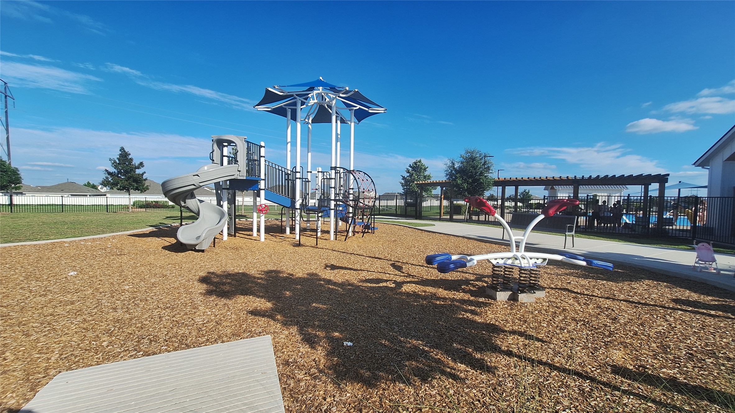 2771 Winding Creek Road Kyle, TX 78640 - Photo 21 of 24 A vibrant playground set against a bright blue sky offers community recreation.