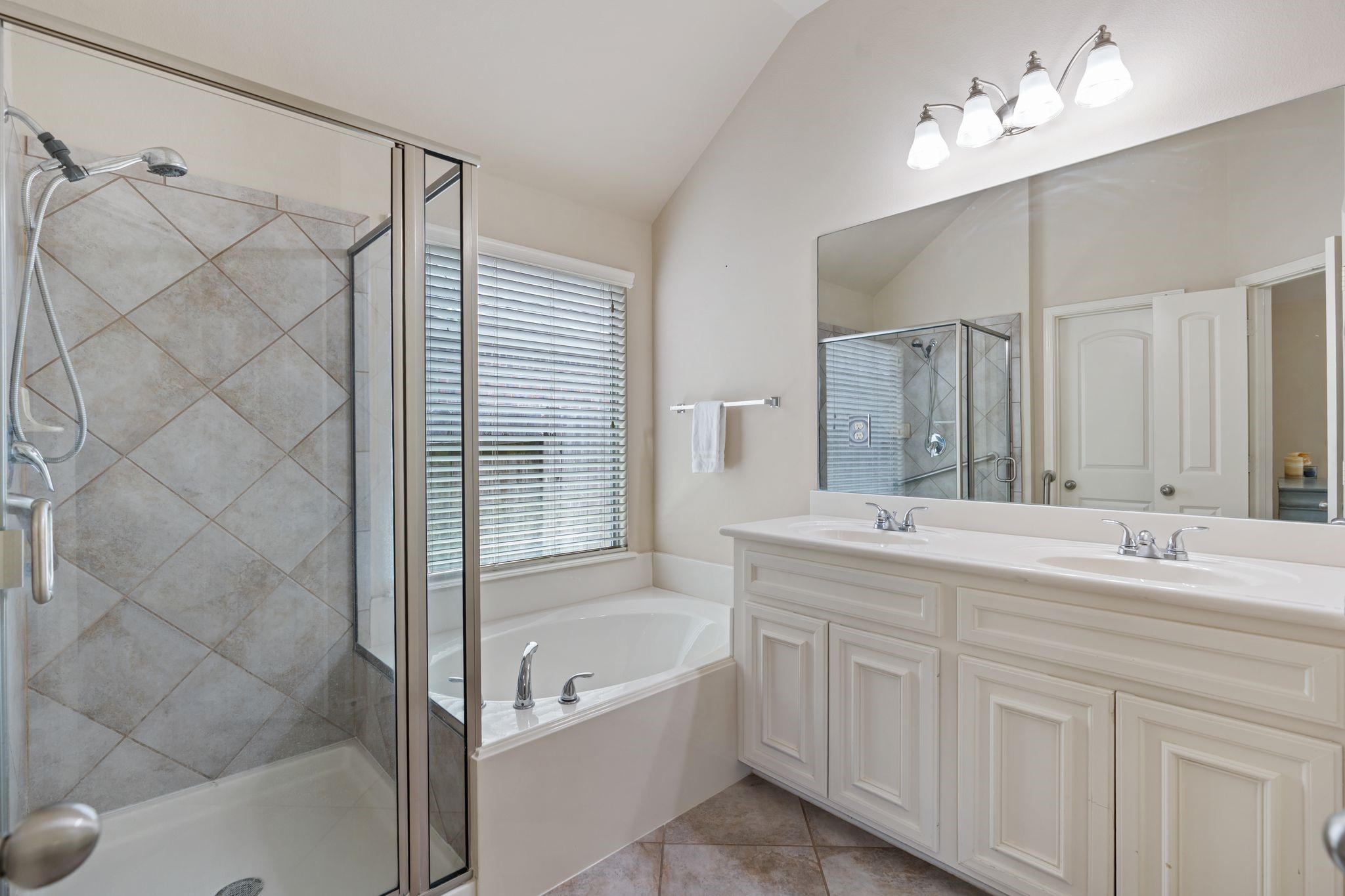 2606 Silverton Bend Rosenberg, TX 77471 - Photo 15 of 26 The primary bathroom features dual sinks, a soaking tub, separate shower, and a spacious walk-in closet.