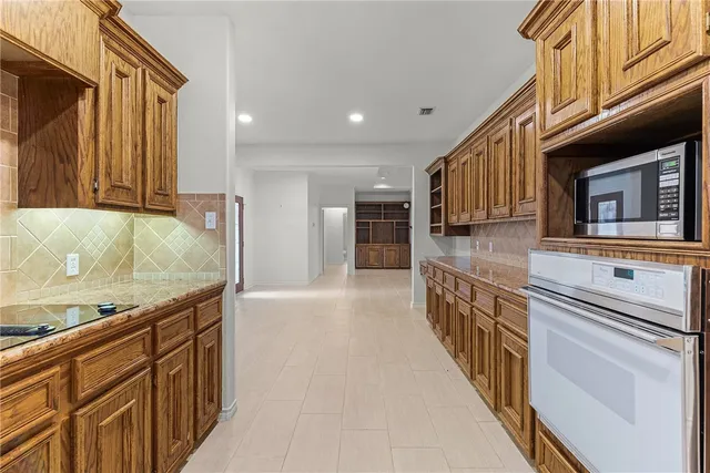 a kitchen with stainless steel appliances granite countertop a sink and cabinets