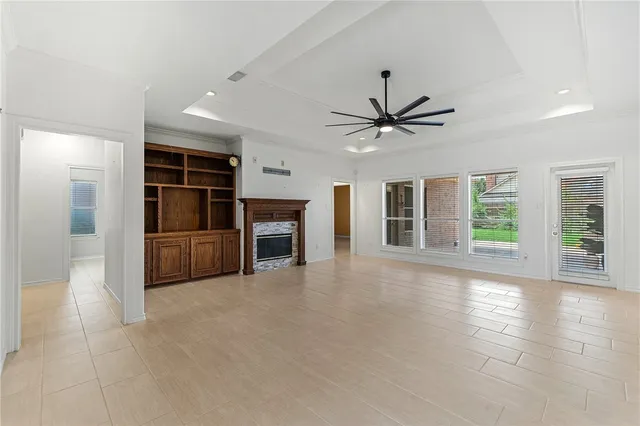 a view of a livingroom with a ceiling fan and window