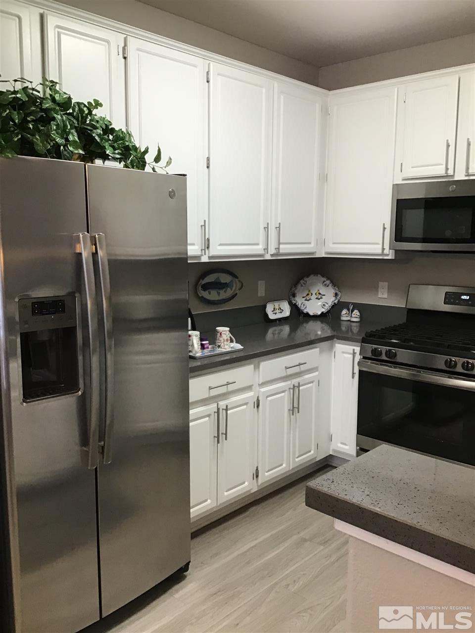 900 South Meadows 1524, Unit 1524 Reno, NV 89521 - Photo 10 of 22 a kitchen with stainless steel appliances granite countertop a refrigerator a stove a sink and white cabinets