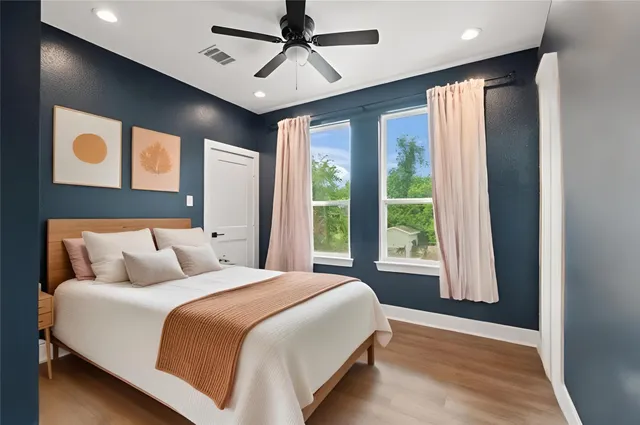 a bedroom with a large bed and a large window