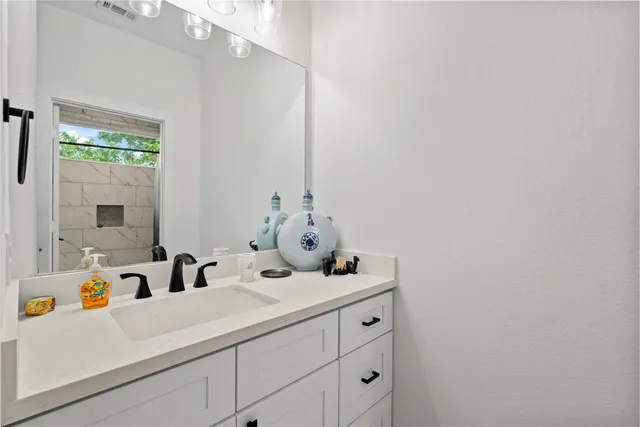 a bathroom with a sink and a mirror