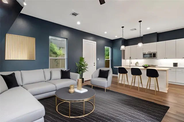 a living room with furniture and kitchen view