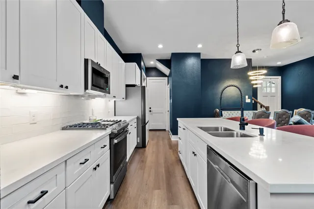 a kitchen with a sink stove and microwave