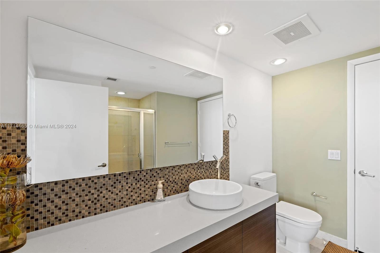 495 Brickell Avenue, Unit 4805 Miami, FL 33131 - Photo 14 of 20 a bathroom with a double vanity sink toilet and a mirror