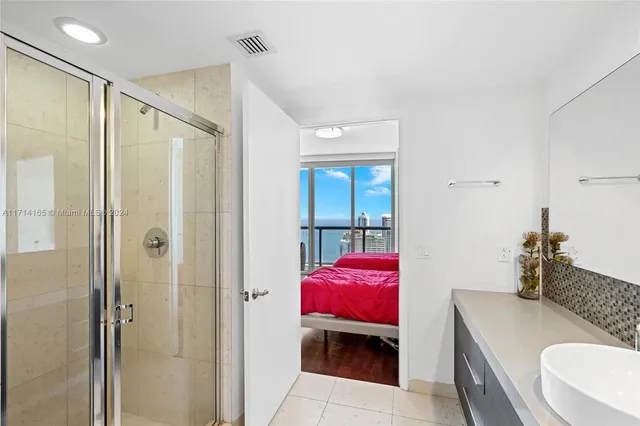 a spacious bathroom with a granite countertop tub sink and mirror