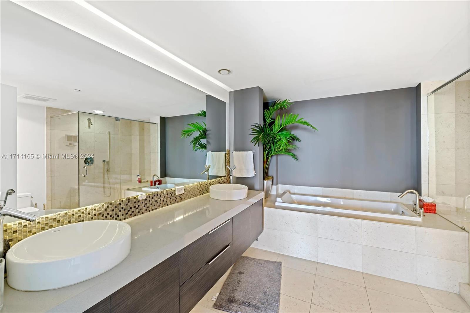 495 Brickell Avenue, Unit 4805 Miami, FL 33131 - Photo 16 of 20 a spacious bathroom with a granite countertop tub sink and mirror