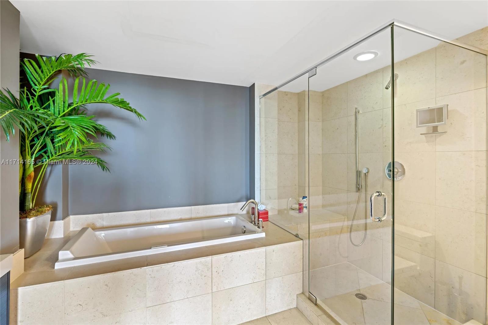 495 Brickell Avenue, Unit 4805 Miami, FL 33131 - Photo 17 of 20 a bathroom with a bathtub and a shower