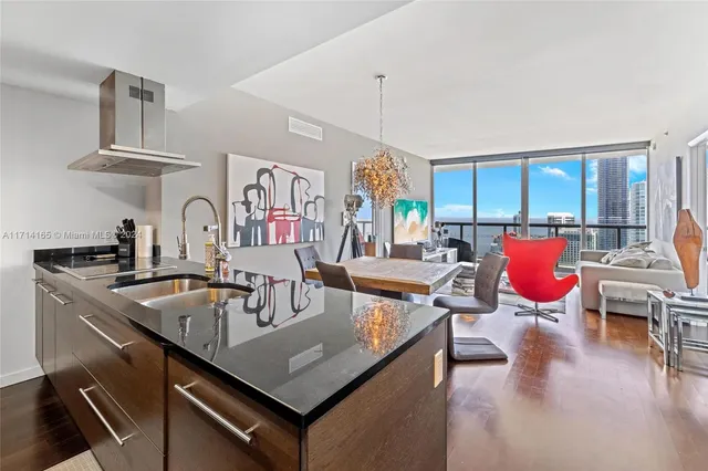 a kitchen with stainless steel appliances granite countertop a sink refrigerator and cabinets