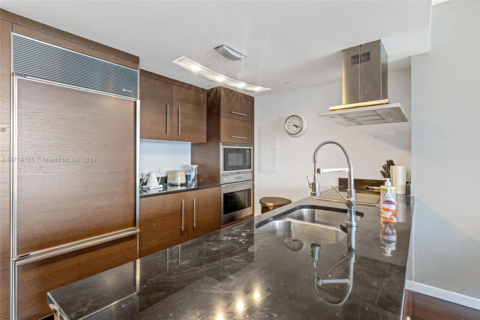 495 Brickell Avenue, Unit 4805 Miami, FL 33131 - Photo 4 of 20 a kitchen with stainless steel appliances granite countertop a sink refrigerator and cabinets