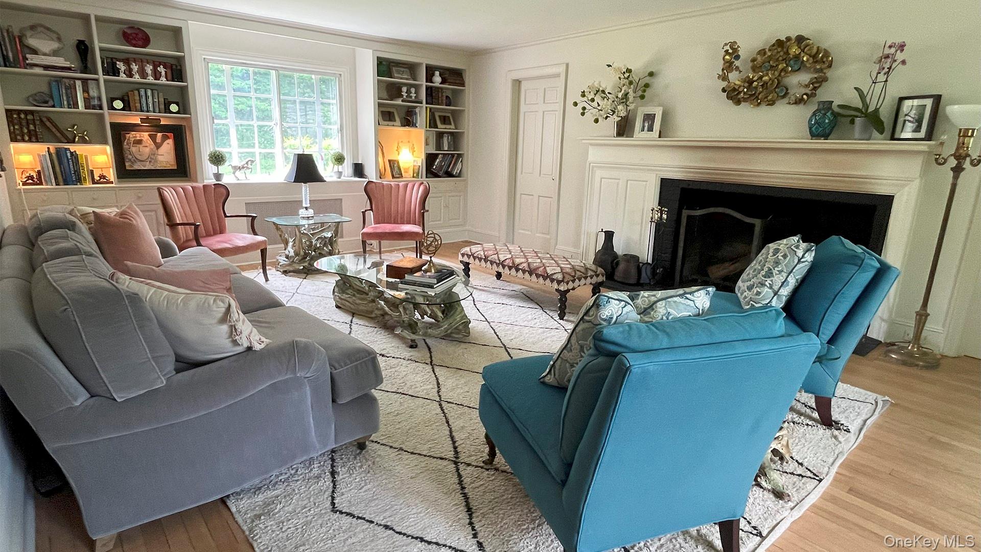 8 Holly Lane Rye, NY 10580 - Photo 15 of 27 Living room featuring wood finished floors, a fireplace, and built in shelves