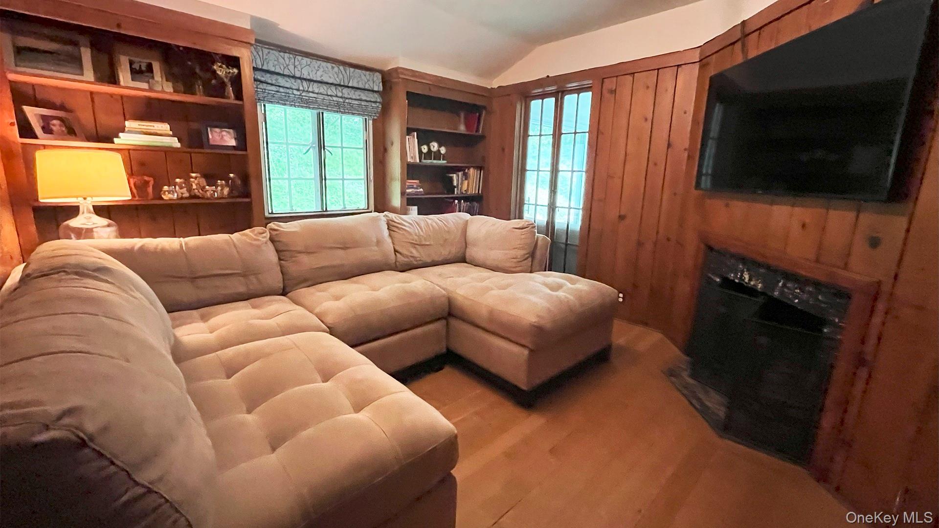 8 Holly Lane Rye, NY 10580 - Photo 17 of 27 Cosy paneled TV room with fireplace and hardwood floors