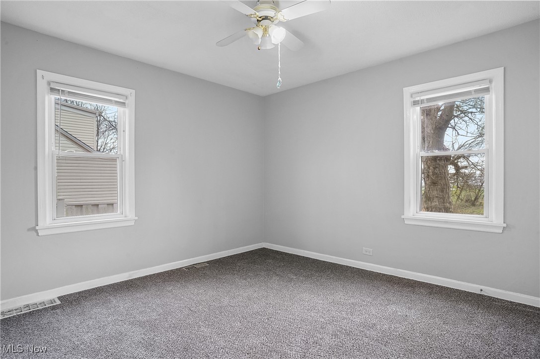 3206 9th Street Northwest Canton, OH 44708 - Photo 19 of 32 Spare room with a wealth of natural light, carpet floors, and ceiling fan
