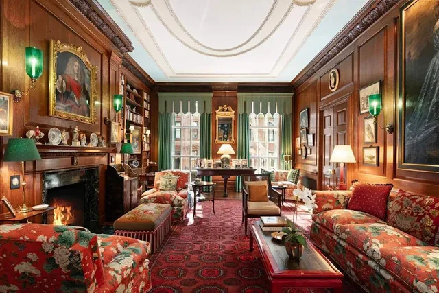a living room with furniture a fireplace and a chandelier