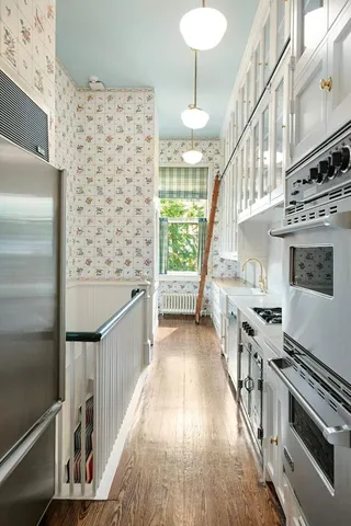 a view of a kitchen with cabinets and stainless steel appliances