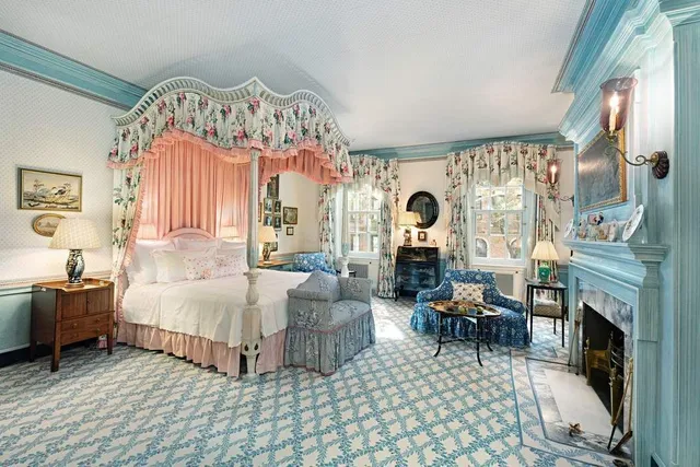 a living room with furniture a fireplace and a large window