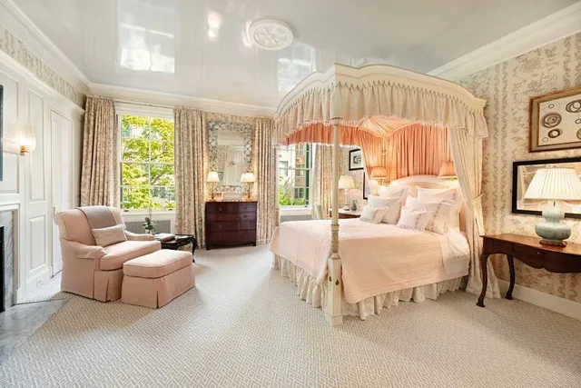 a spacious bedroom with a bed and a large window